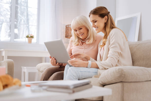 istock Nice elderly woman learning how to use a laptop 941665598