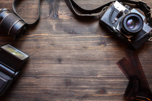 istock Old retro camera on wooden table background 941665694