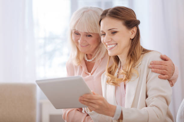 istock Delighted young woman holding a tablet 941669006