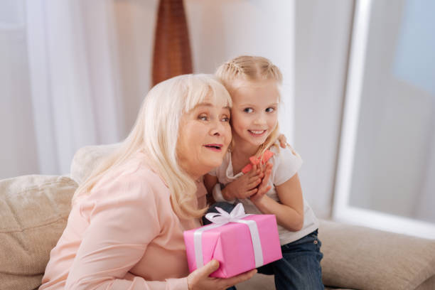 istock Delighted aged woman hugging her granddaughter 941670312