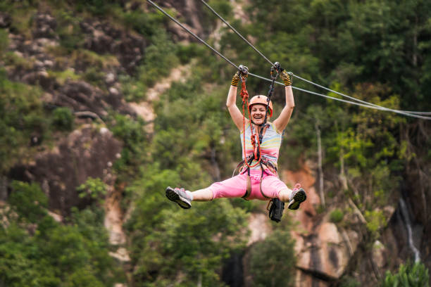 istock Cheerful woman having fun during canopy tour in the forest. 941672968