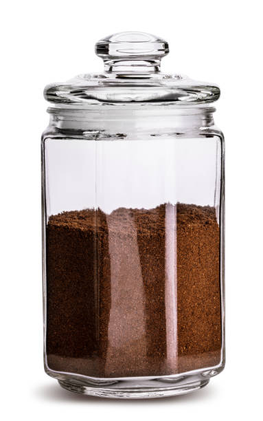 istock Glass jar with coffee beans isolated. Clipping path. 941673534