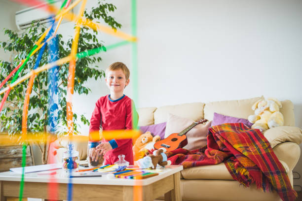 istock Untidy home. Boy playing with toys 941674570