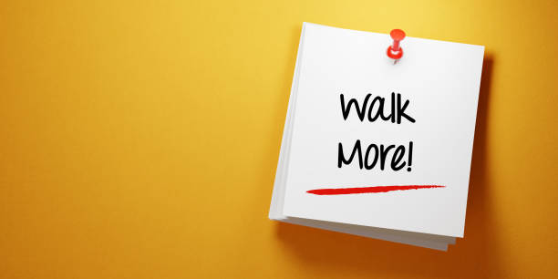istock White Sticky Note With Walk More Message And Red Push Pin On Yellow Background 941676794