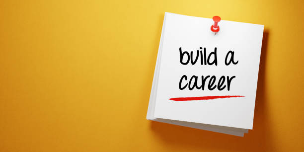 istock White Sticky Note With Build A Career Message And Red Push Pin On Yellow Background 941677364