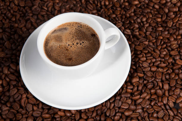 istock white cup of coffee at coffee beans backgrounds 941677532