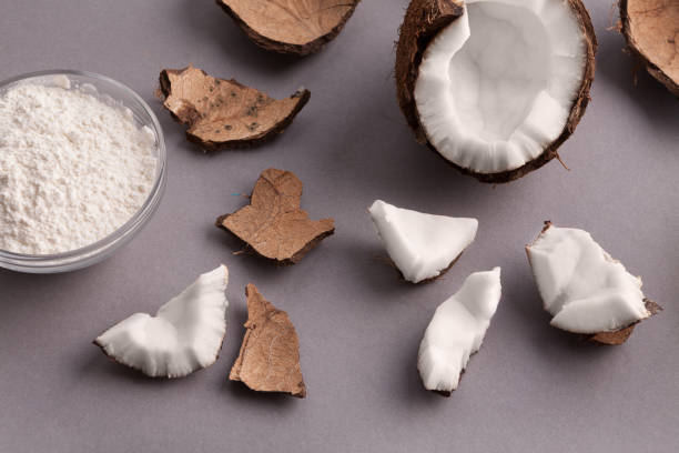 istock Plate with coconut flour and nuts on grey background 941677566