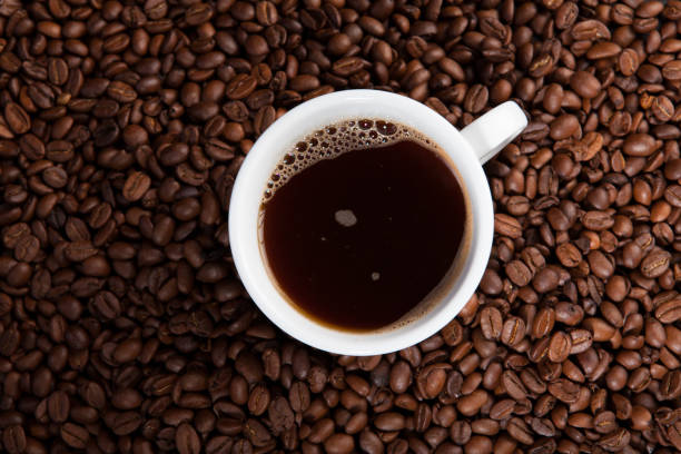 istock white cup of coffee at coffee beans backgrounds 941677622