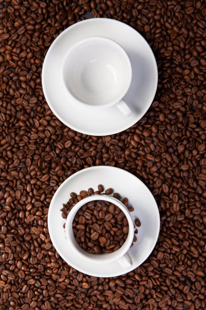 istock white cup of coffee at coffee beans backgrounds 941677690