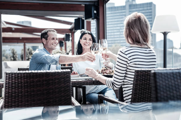 istock Positive delighted people cheering with wine 941677852