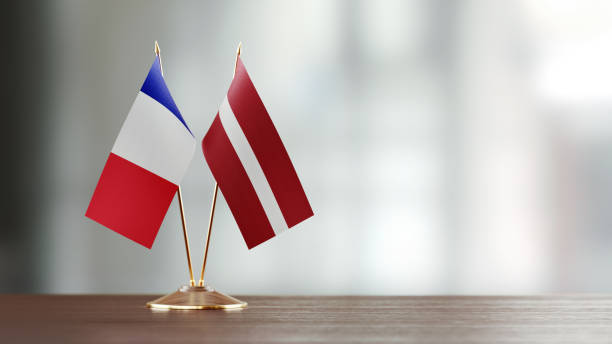 istock French And Latvian Flag Pair On A Desk Over Defocused Background 941681836