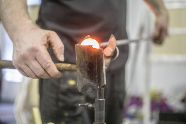 Glass blowing in factory Traditional glassblowing worker shaped liquid glass hand blown glass stock pictures, royalty-free photos & images