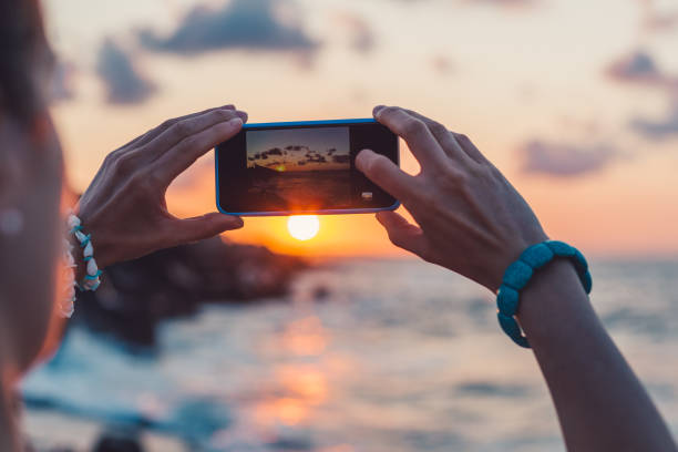 istock Woman photographing the sunset 941682240