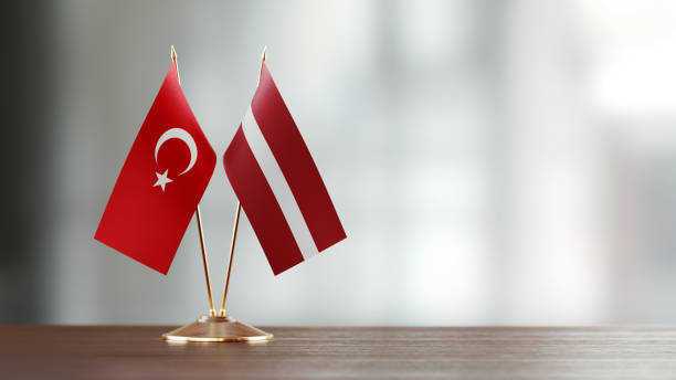 istock Turkish And Latvian Flag Pair On A Desk Over Defocused Background 941683000