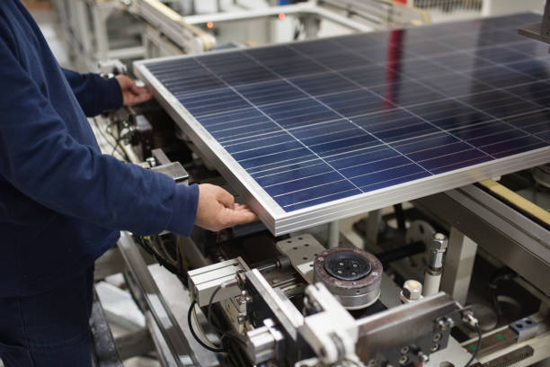production of solar panels, man working in factory. production of solar panels, man working in factoryproduction of solar panels, man working in factory solar panel manufacturing stock pictures, royalty-free photos & images