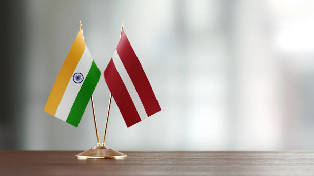 istock Indian And Latvian Flag Pair On A Desk Over Defocused Background 941684064