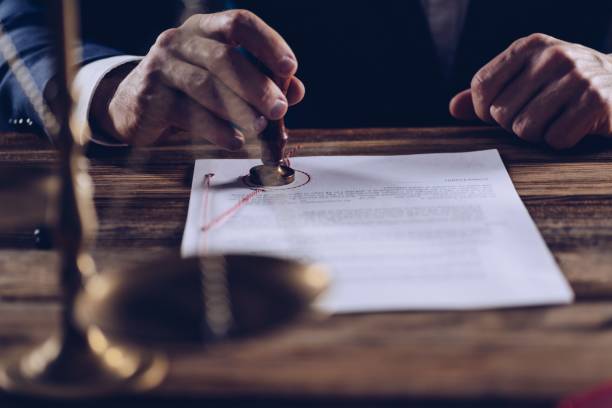 istock Male lawyer or notary stamping document in his in office. 941685502