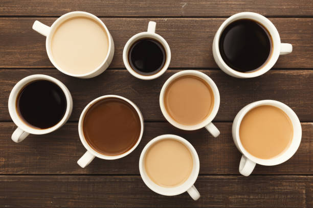 istock Different types of coffee in cups on wooden table, top view 941686766