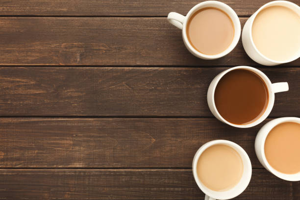 istock Different types of coffee in cups on wooden table, top view 941686850