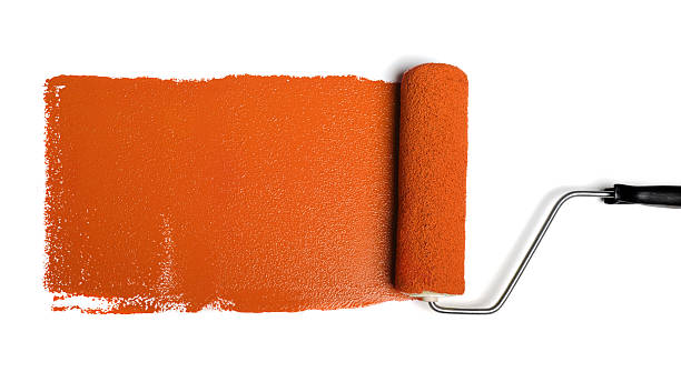 Roller With Orange Paint stock photo