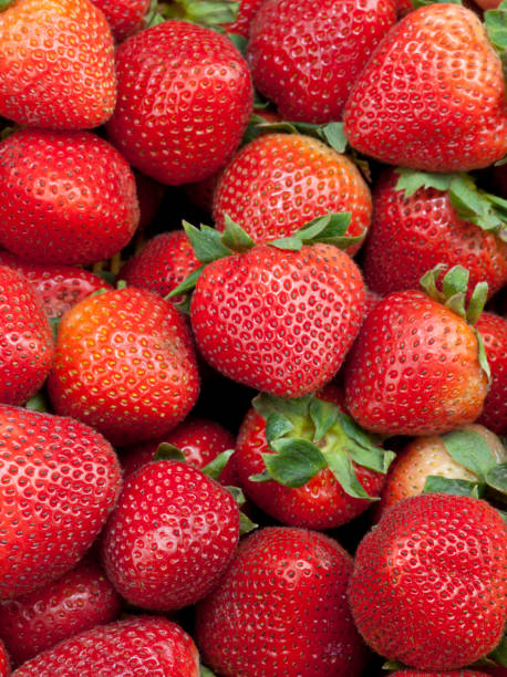 istock Fresh Strawberries with Green Leaves 941690736