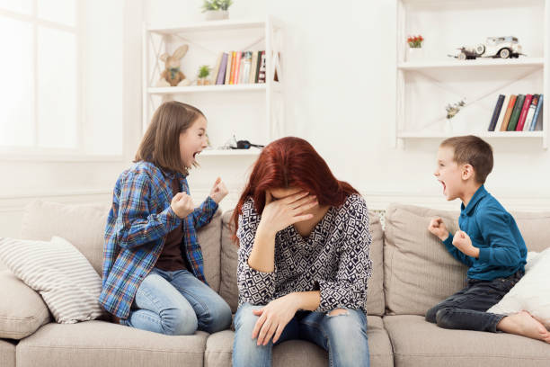 istock Kids having quarrel over tired mother 941690760
