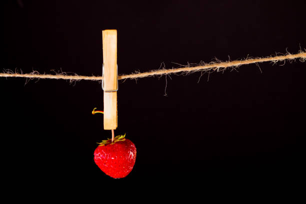 istock Cherry and rope on black with clamp 941691788