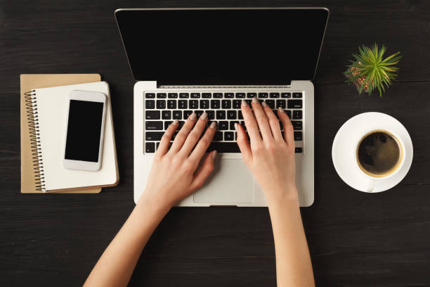 istock Woman's hands on laptop keyboard, top view 941695108