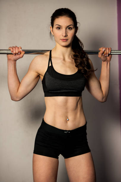istock Beautiful fit woman making squats in gym 941698730