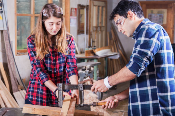 istock Beautiful young couple  in their studio Constructing a Boat Model 941698790