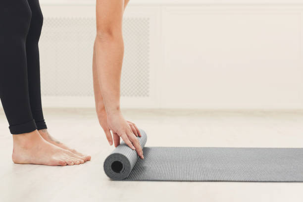 istock Rolling up fitness mat for exercise copy space 941702330