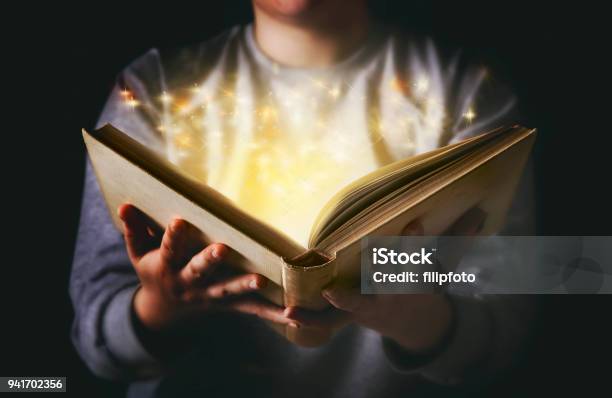 Light Coming From Book In Womans Hands In Gesture Of Giving Stock Photo - Download Image Now