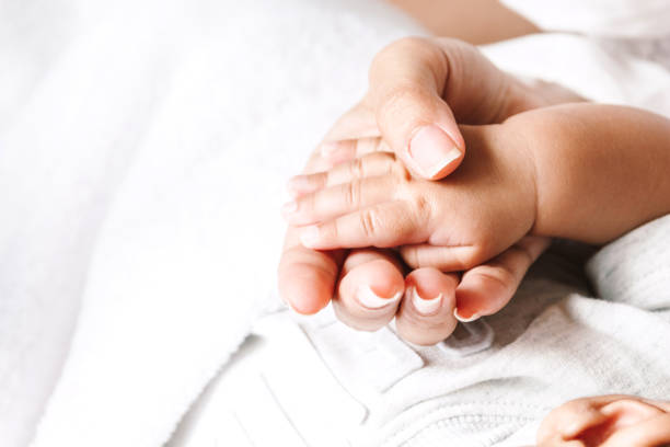 istock Baby hand in hand mother 941702554