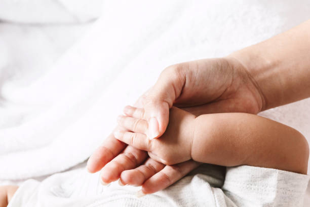 istock Baby hand in hand mother 941702608
