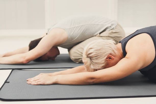 istock Fitness couple stretching at white background 941702676