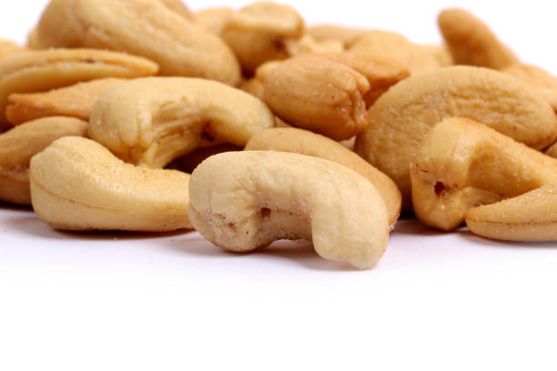 istock Unshelled roasted and salted cashew nuts isolated on white background 941703582