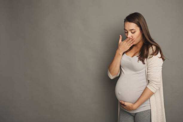 istock Young vomiting pregnant woman at studio 941705368