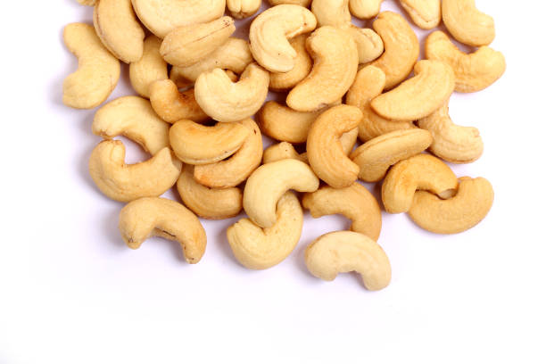istock Unshelled roasted and salted cashew nuts isolated on white background 941705398