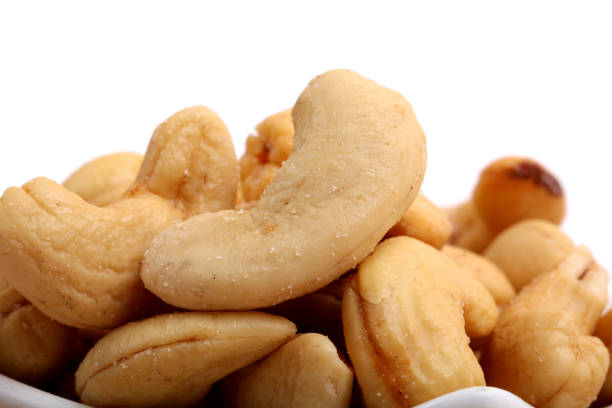 istock Unshelled roasted and salted cashew nuts isolated on white background 941705564