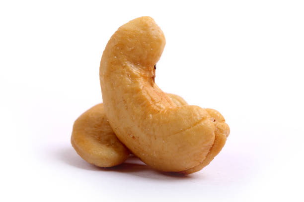 Unshelled roasted and salted cashew nuts isolated on white background