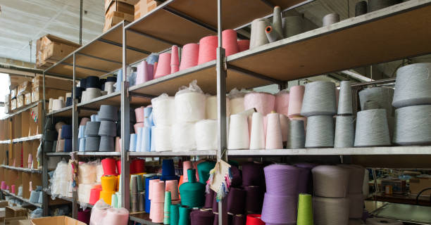 istock Spools with different color thread at knitting factory 941706088