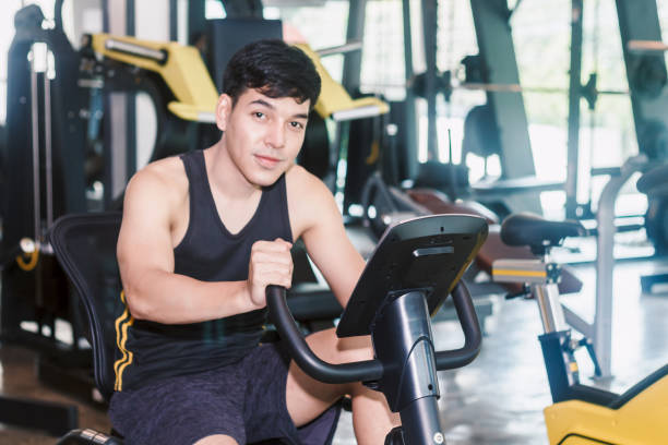 istock Fitness man execute exercise with exercise-machine at the gym 941715468