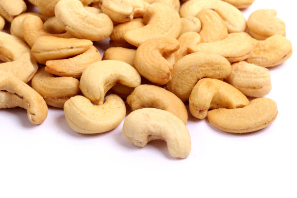 istock Unshelled roasted and salted cashew nuts isolated on white background 941715536