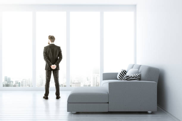 istock Man in bright living room 941716208