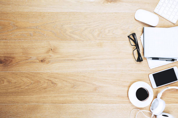 istock Wooden office desk top with items 941716622