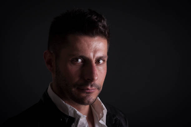 istock A serious caucasian man on dark background 941720204
