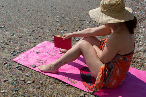 Beautiful woman reading a book on beach AntalyaBeautiful woman reading a book on beach Antalya