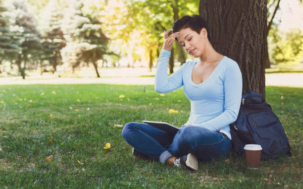 istock Attractive woman with tablet outdoors 941723902