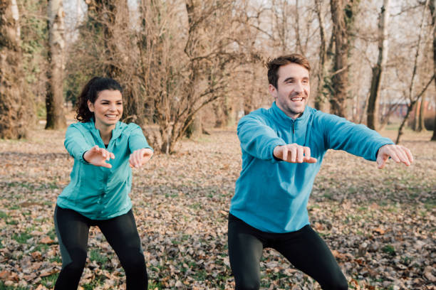 istock Athletic couple doing squats outdoors 941724138