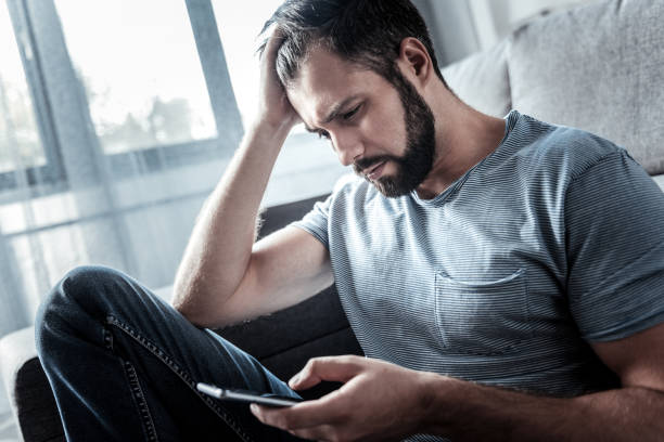 istock Cheerless unhappy man holding his head 941724316